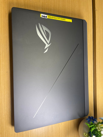 ASUS ROG Strix G16 gaming laptop closed, showing the ROG logo on the grey aluminium lid