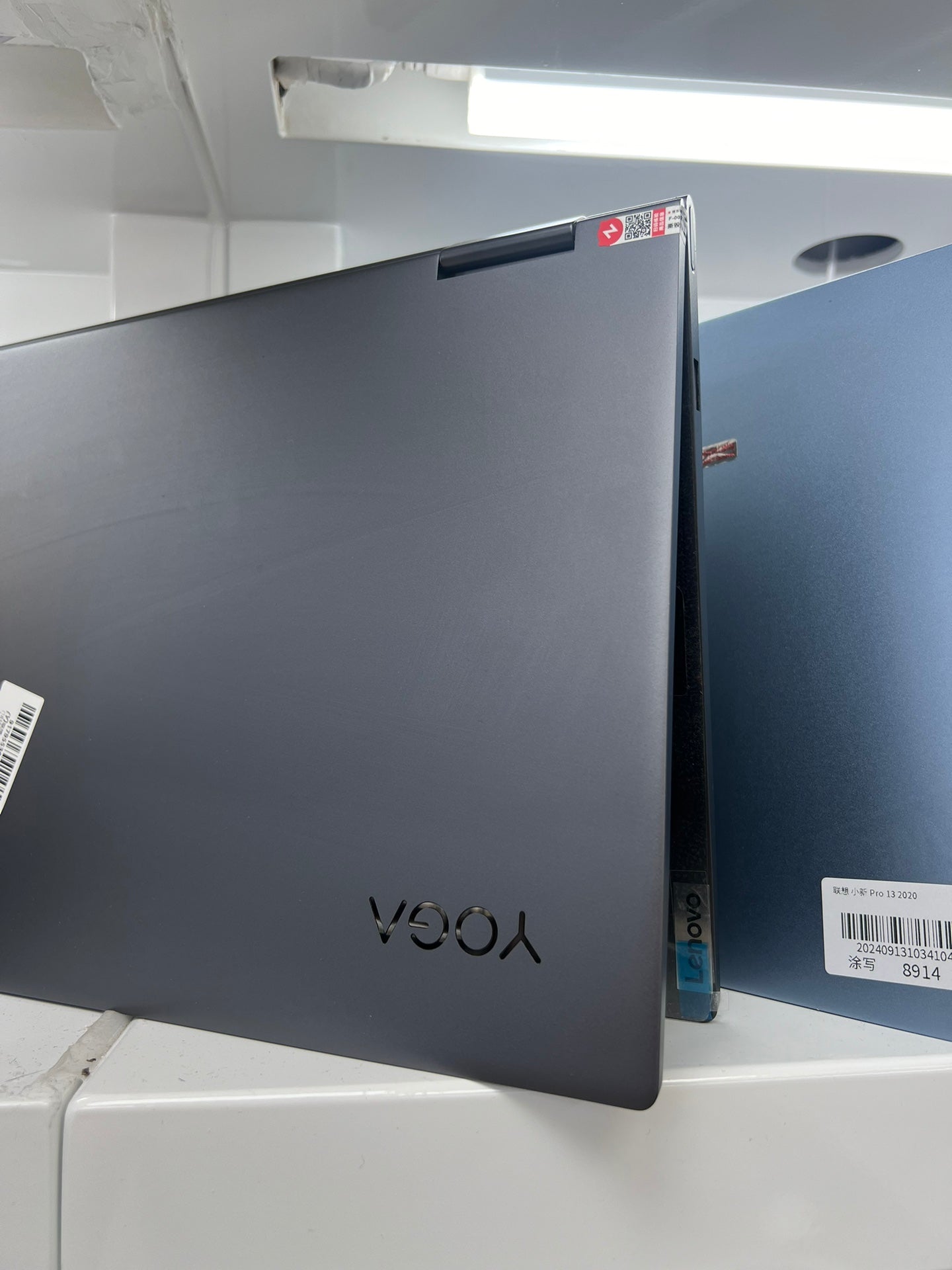 Side view of the closed Lenovo Yoga C740 showing the 360-degree hinges