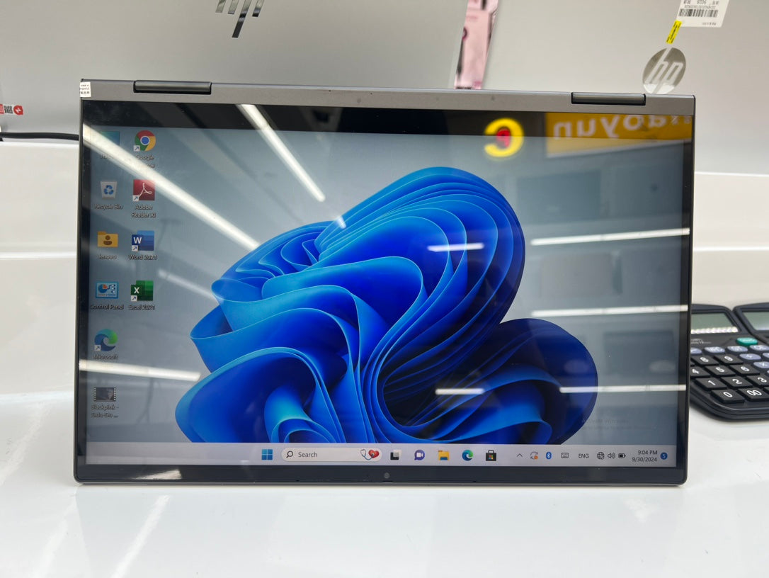 Lenovo Yoga C740 folded flat in tablet mode with the Windows 11 desktop on screen