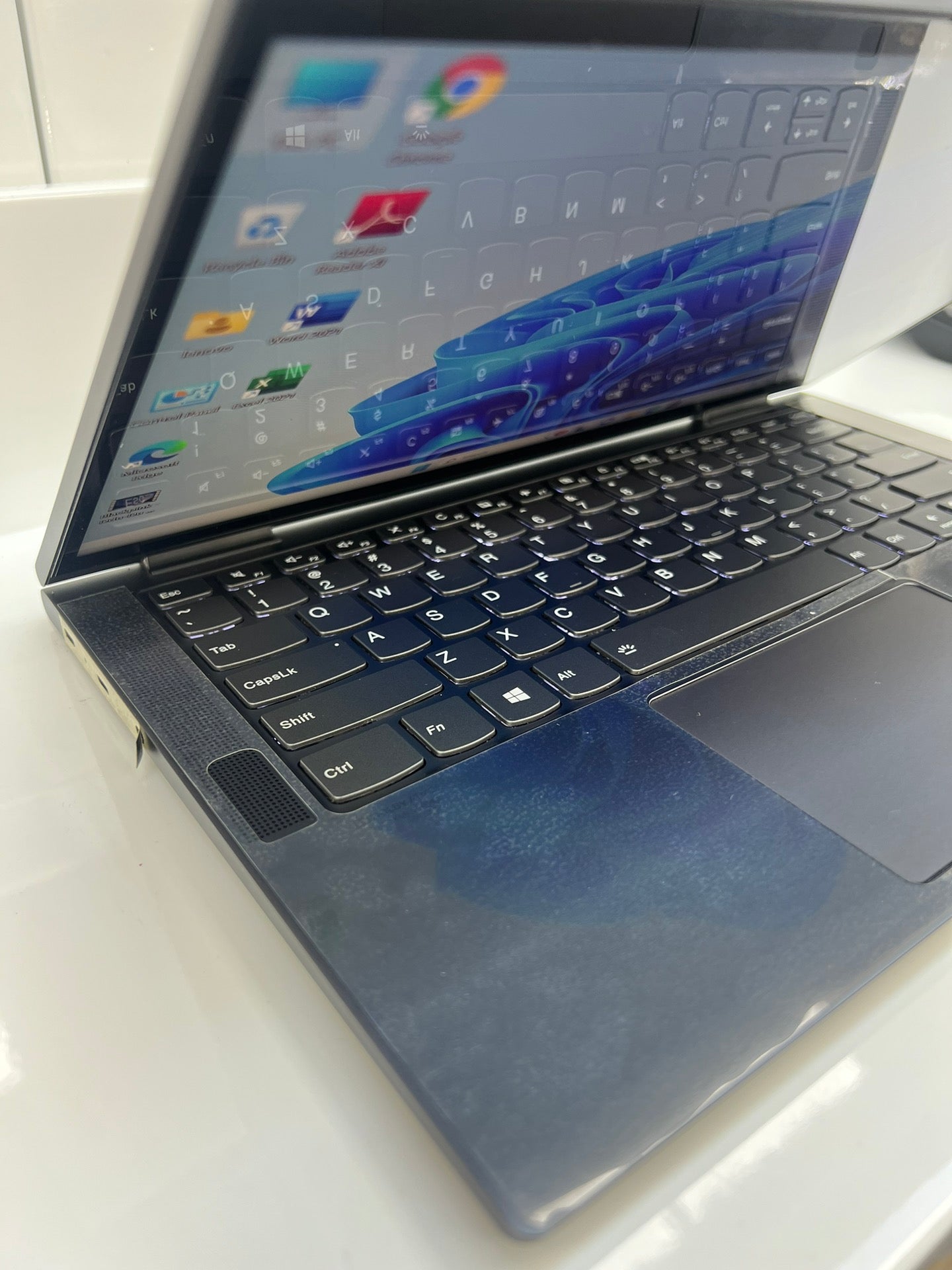 Angled view of the Lenovo Yoga C740 keyboard and hinge, showing the slim aluminium chassis